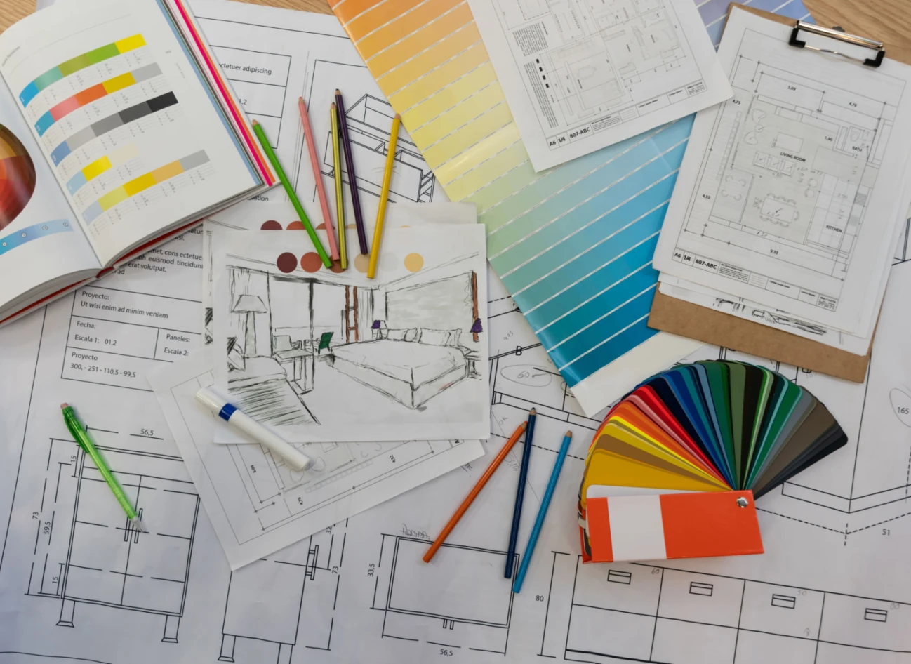 Architectural plans with color swatches and pencils.