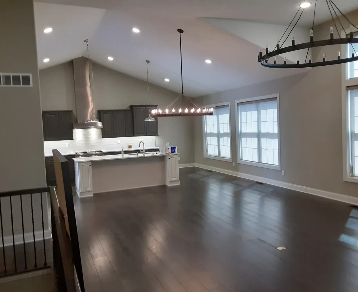 Spacious kitchen and living area with chandelier.